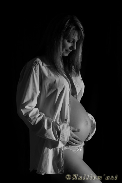 Photographie d'une femme enceinte regardant son ventre réalisée par Huitièm'art, photographe de mariage à Avignon (Vaucluse)