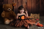 Photographie d'une petite fille assise devant un ours en peluche pour halloween citrouille  réalisée par Noelle Gamand Huitm'art, photographe à Avignon (Vaucluse)